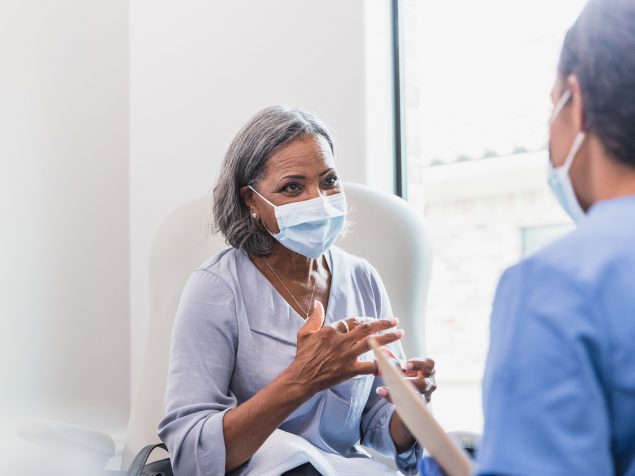 A physician working with an elderly patient.