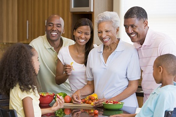 Family preparing a meal together in the kitchen.